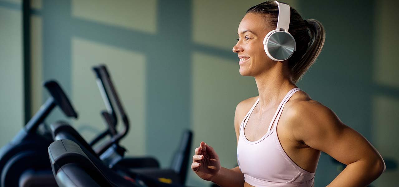 Auriculares deportivos mujer en una cintas de correr